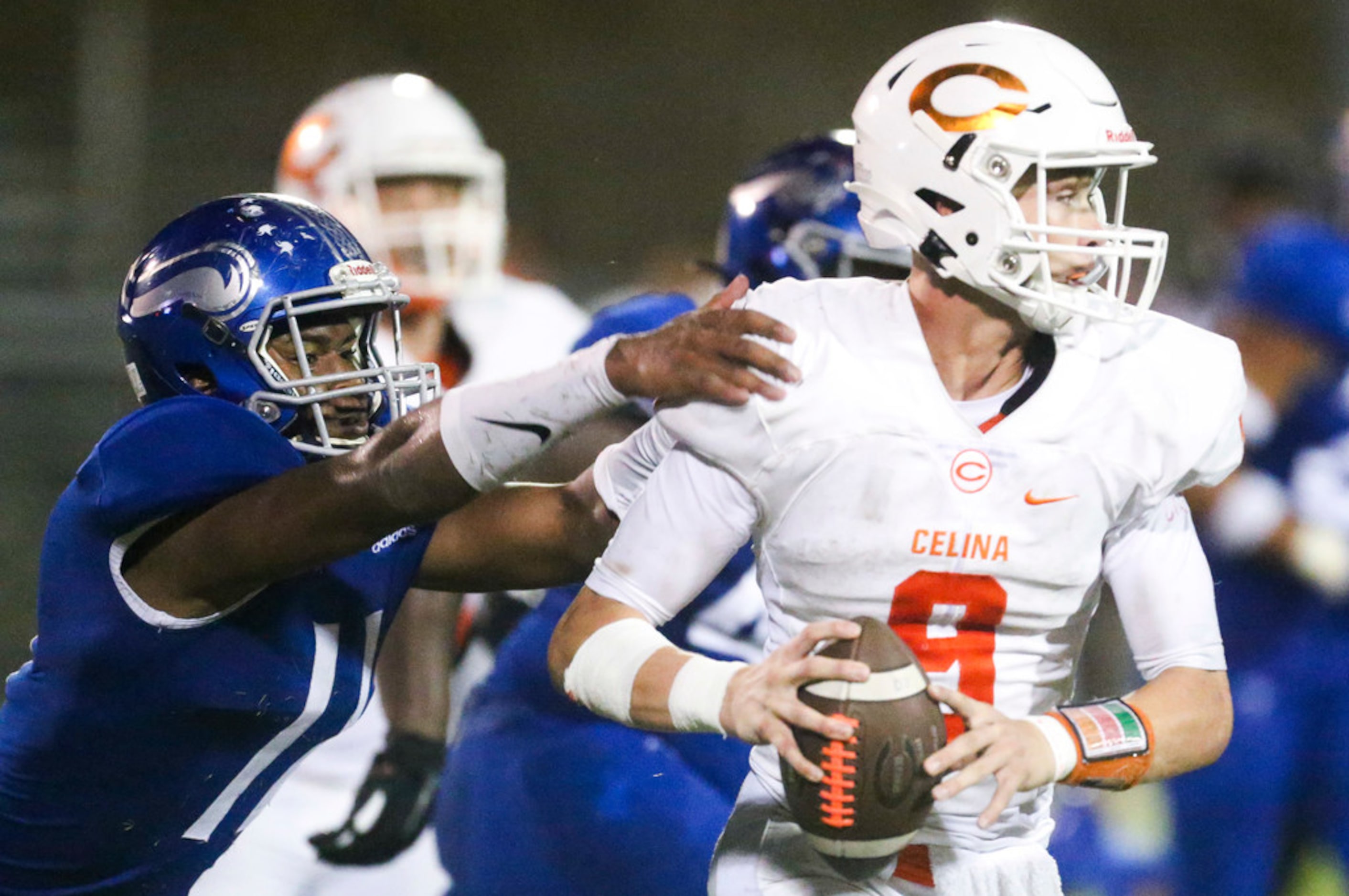 Celina quarterback Hunter Watson (9) looks to pass as Nolan Catholic defensive lineman...