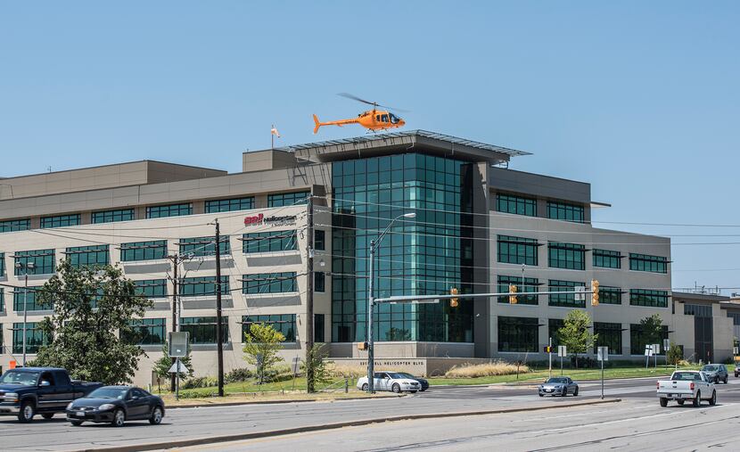 A 505 Jet Ranger helicopter lands atop Bell Helicopter's Fort Worth headquarters.