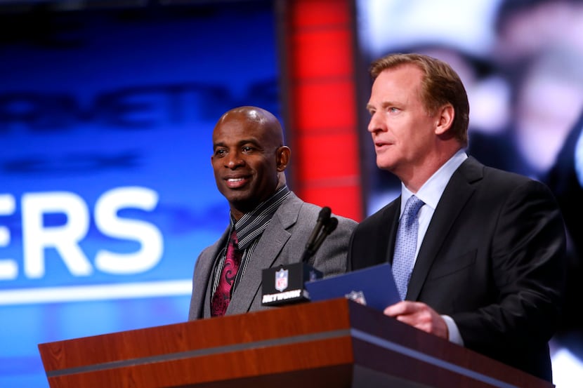 Deion Sanders, left, is introduced by NFL football commissioner Roger Goodell before...