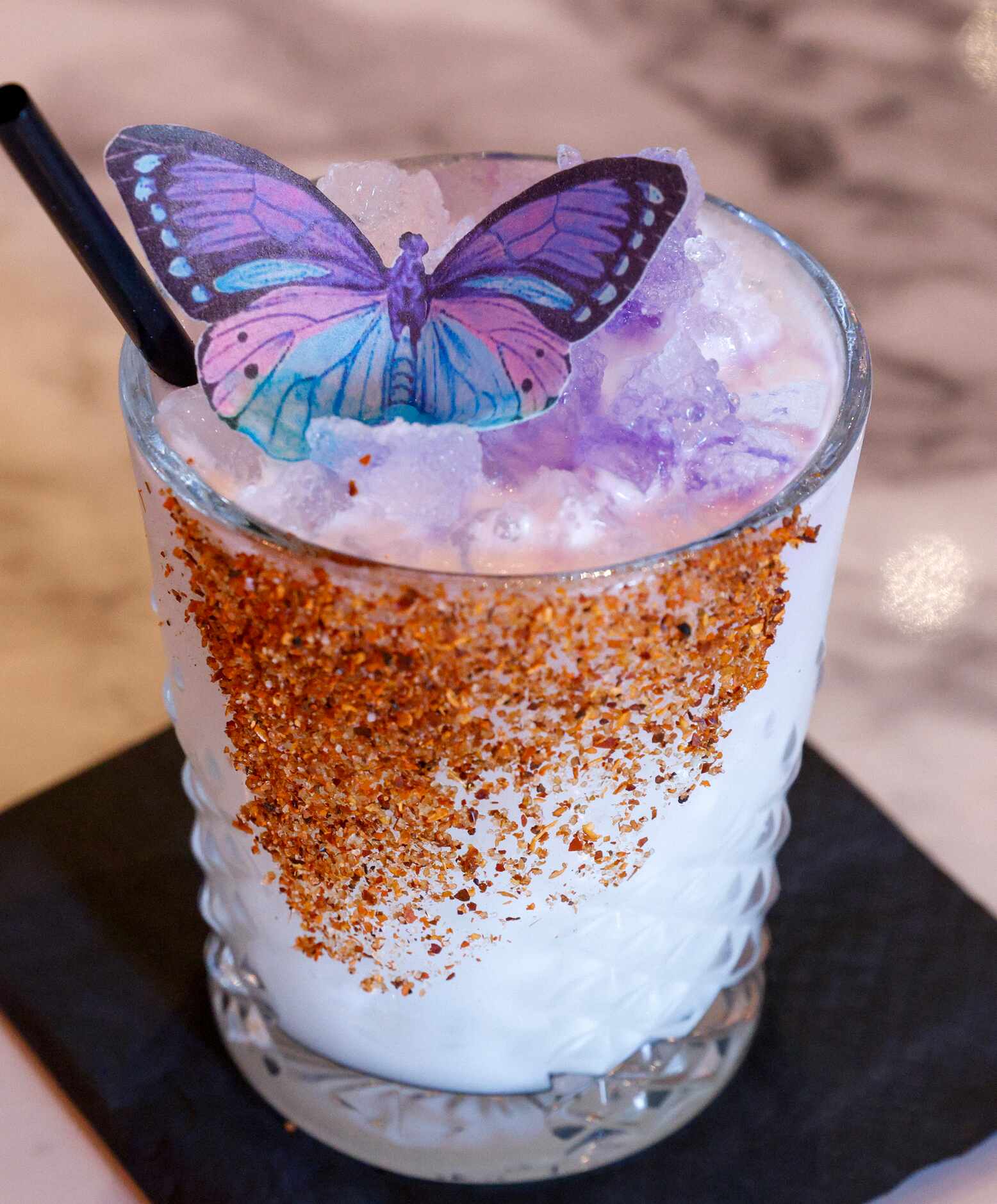 The Snowbird, a signature cocktail served with an edible butterfly made from a wafer, at...