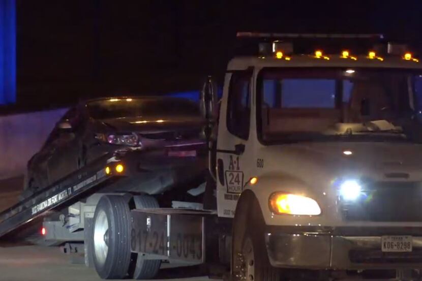 A silver Honda is loaded onto a tow truck after it crashed during a high-speed police chase...