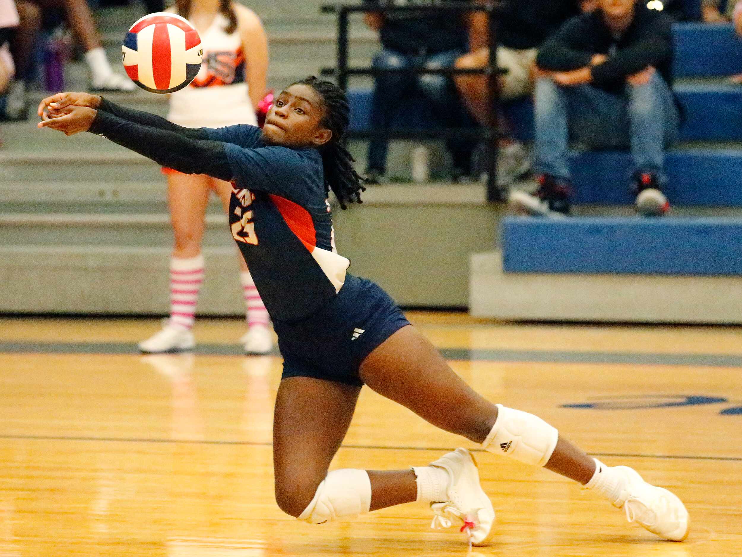 Sachse High School defensive specialist Zoria Heard (25) attempts to save a point during...