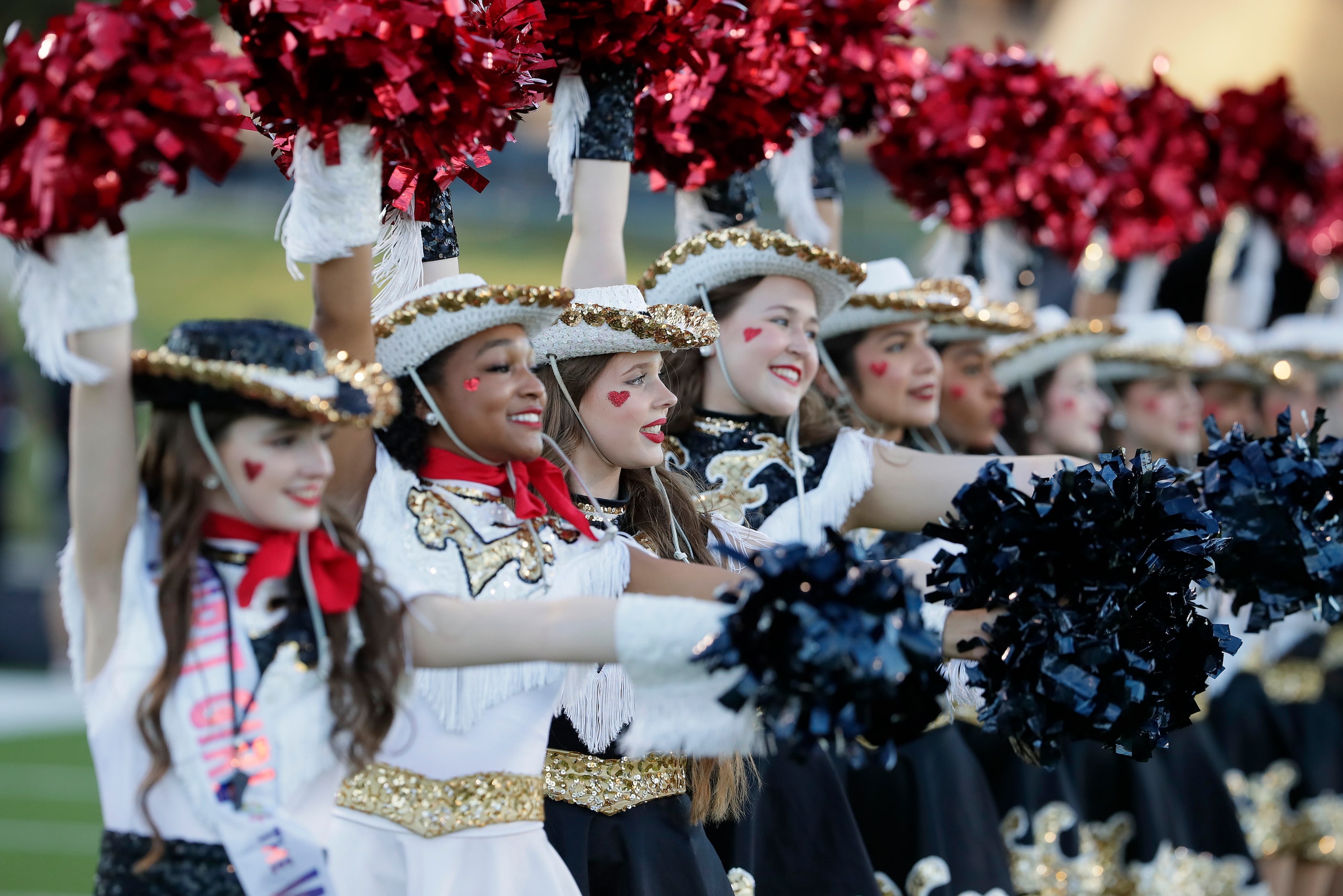 The Plano East High School Golden Girls drill team performs before kickoff as Plano East...