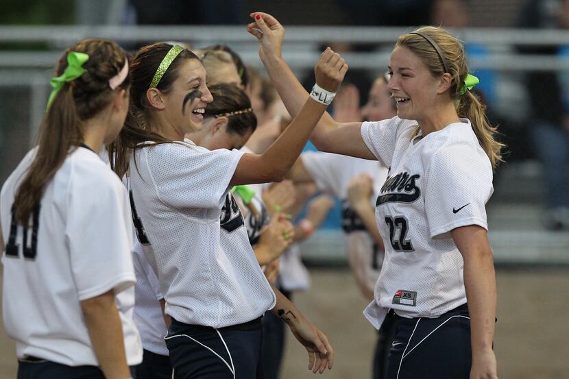 Flower Mound catcher Christy Lisenby (22) and Cassie White (14) share during team...