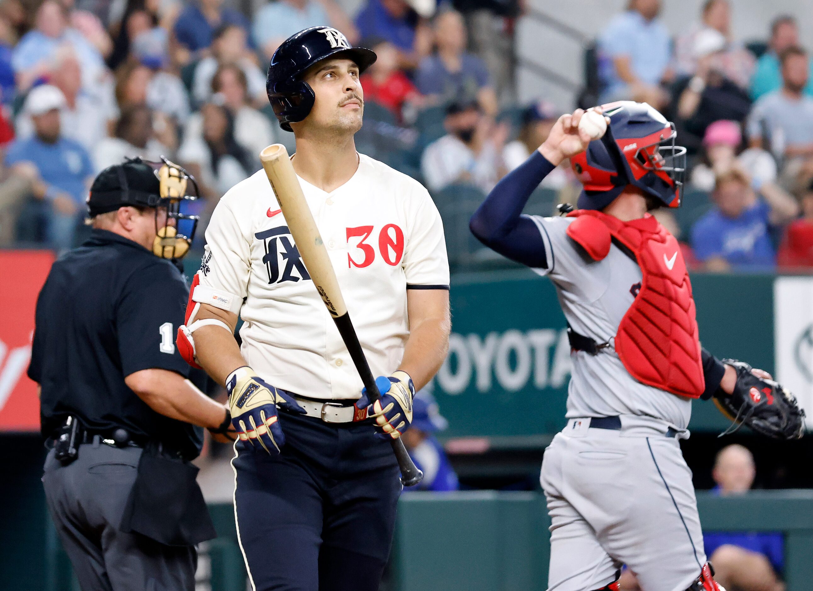 Texas Rangers batter Nathaniel Lowe (30) walks to the dugout after striking out to end the...