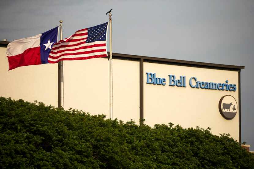  Flags flutter in the breeze outside of the Blue Bell Creameries on Thursday, April 23,...
