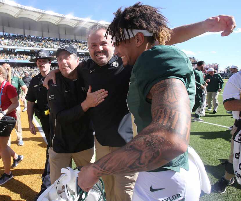 Baylor head coach Matt Rhule, center, celebrates their win against Oklahoma State with...