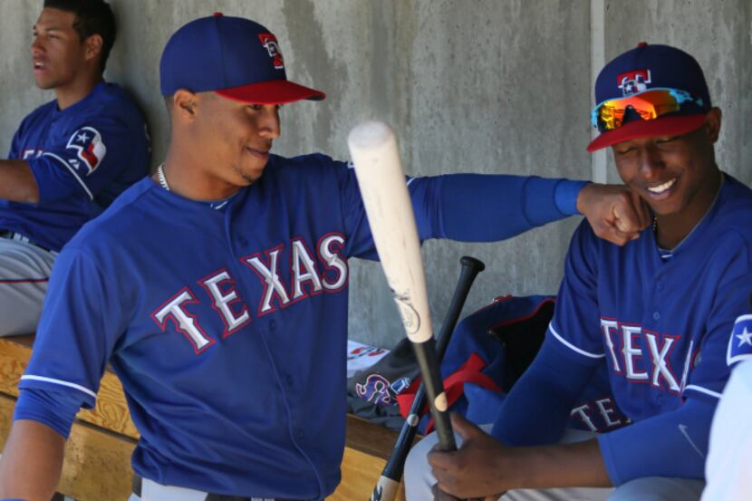 Texas outfielder Leonys Martin, left, playfully pretends to land a punch on infielder...