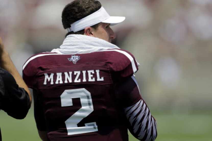Texas AM's Johnny Manziel watches from the sidelines during the second quarter of an NCAA...