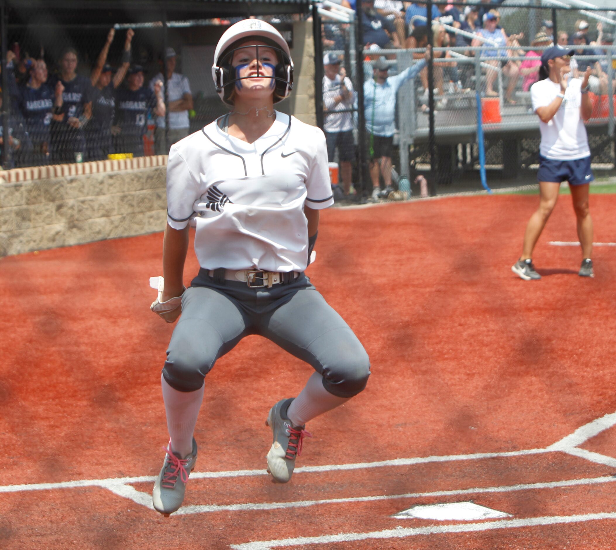 Keller's Cambree Cribbs (20) leaps in celebration after scoring in the top of the 7th inning...