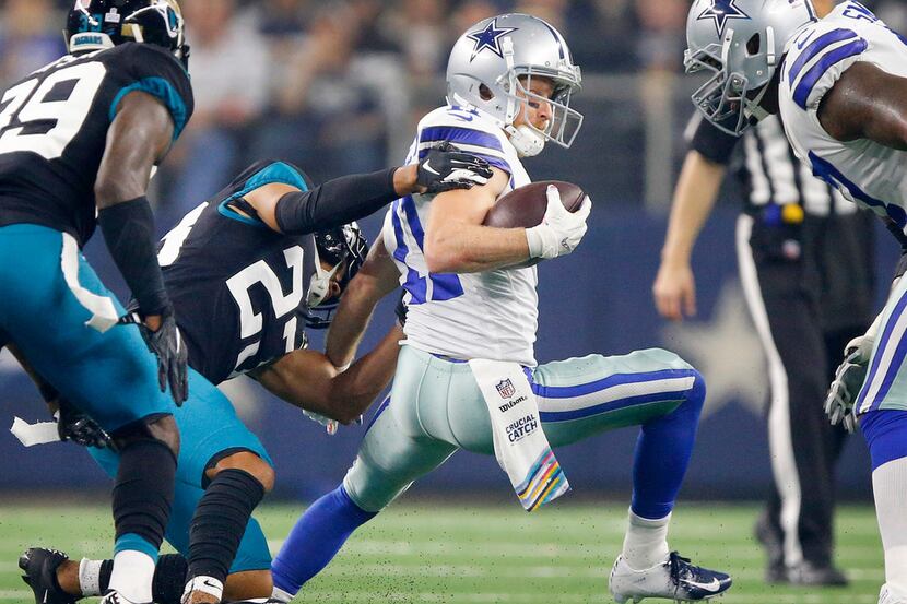 Dallas Cowboys wide receiver Cole Beasley (11) tries to escape the grasp of Jacksonville...