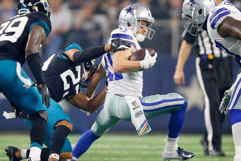 Dallas Cowboys wide receiver Cole Beasley (11) tries to escape the grasp of Jacksonville...