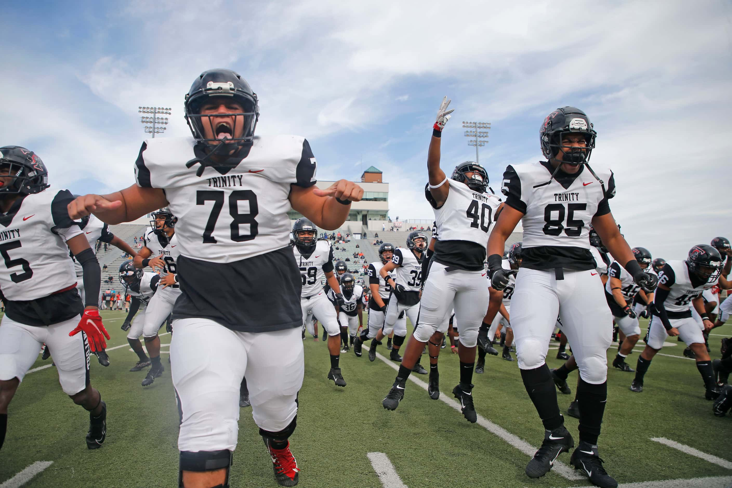 Euless Trinity players Jacob Foni (78),  Kaerreyn Carter (40) and Xzavior Kautai (85) take...