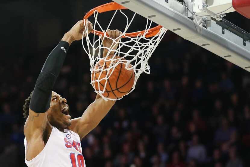Southern Methodist Mustangs guard Jarrey Foster (10) dunks the ball over UCF Knights center...