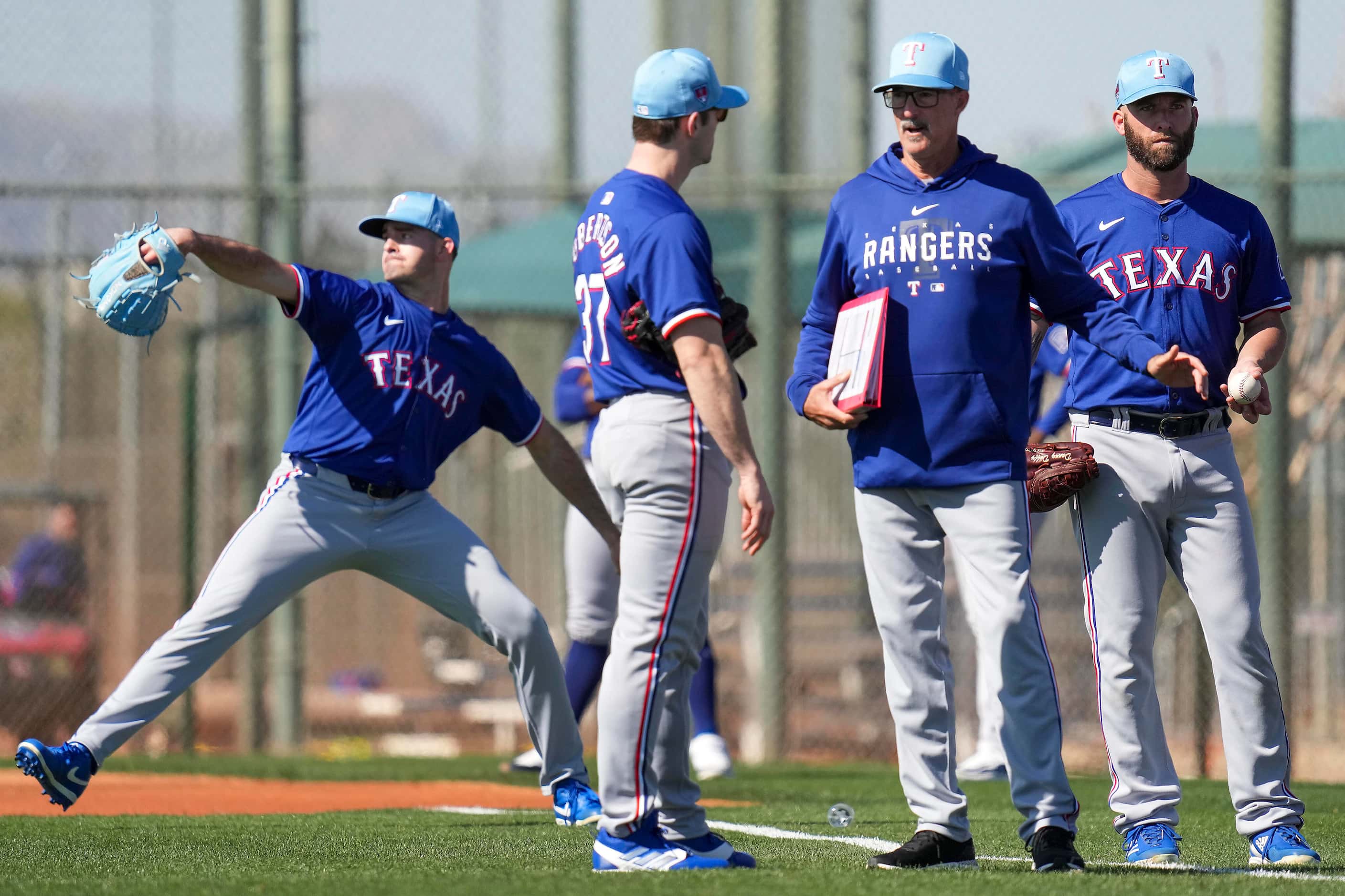 Texas Rangers pitcher David Robertson (37) talks with pitching coach Mike Maddux during a...