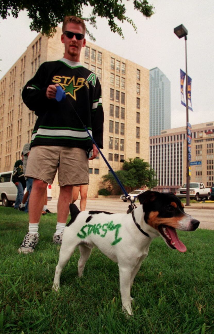Dallas Stars fan Brian Atlas and his dog Fletch, who Atlas decorated, get ready to see the...