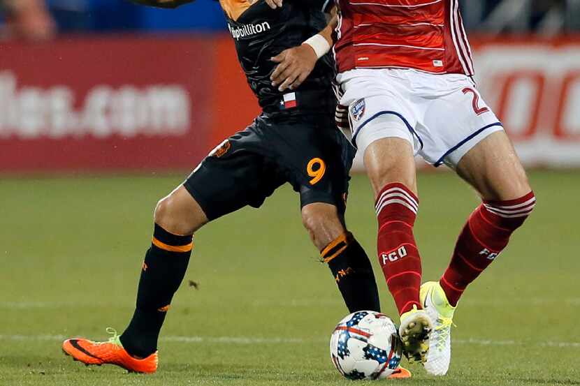 Houston Dynamo forward Erick Torres (9) and FC Dallas defender Matt Hedges (24) compete for...