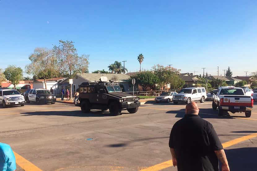 This photo provided by Marco Soto shows police vehicles outside a middle school in Asuza,...