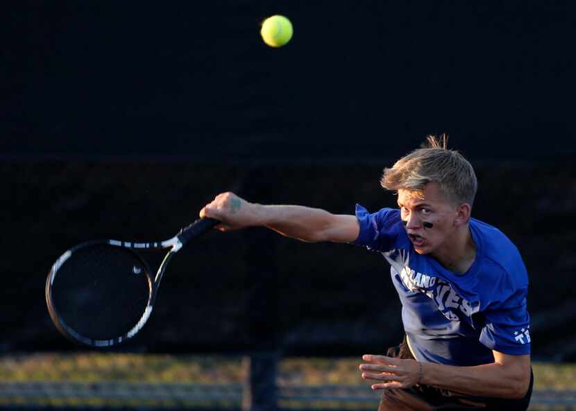 Plano West's Harrison Sites serves the ball in a doubles match with teammate Anup Arvind...