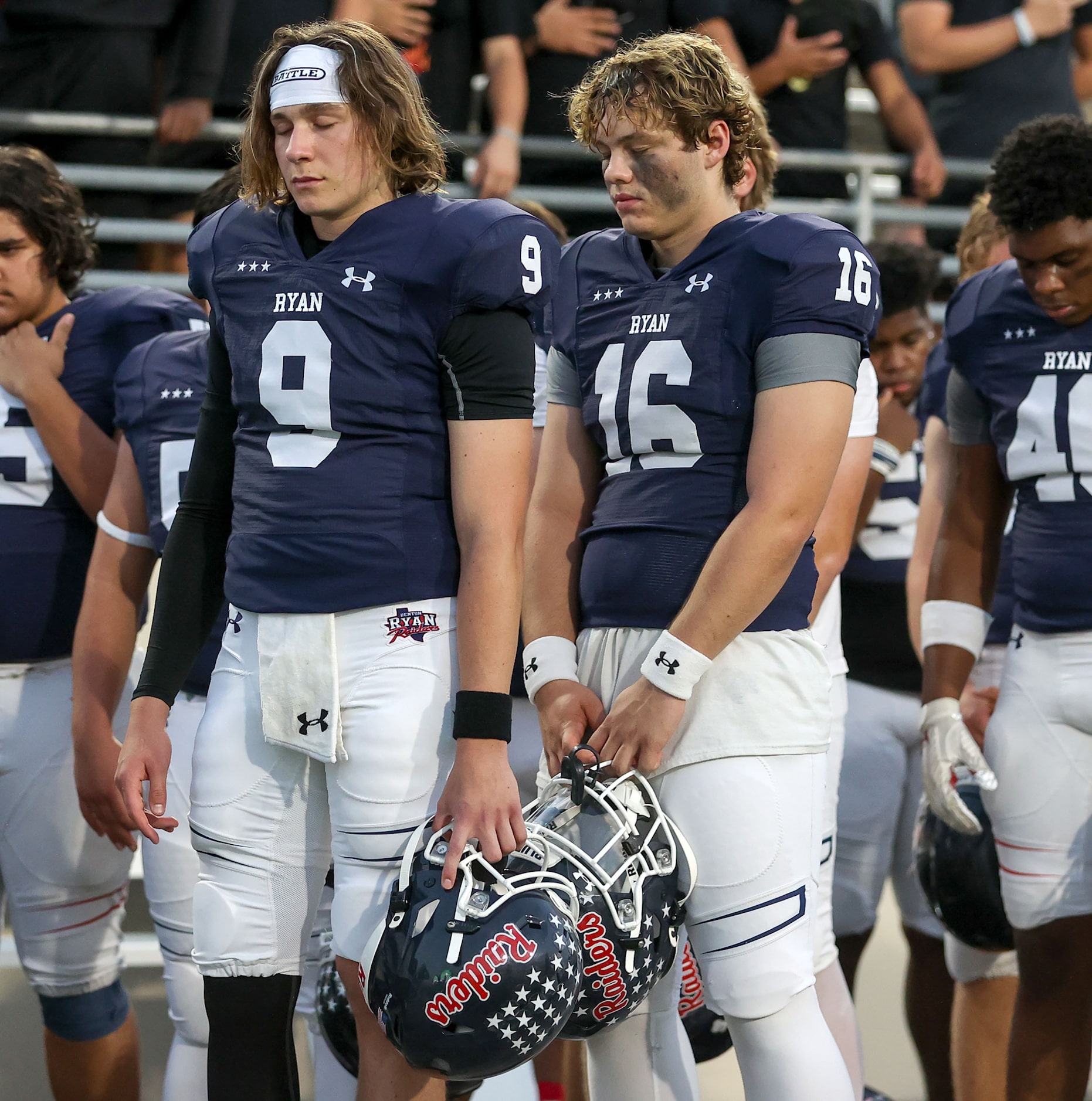 Denton Ryan quarterback Quin Henigan (9) and quarterback Brady Cardwell (16) take a moment...