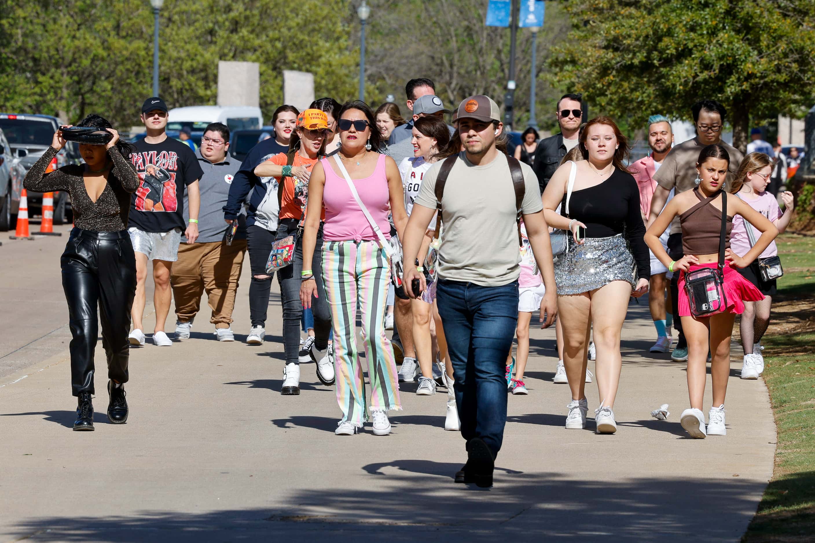 Fans walk along Randol Mill Road before a Taylor Swift Eras Tour concert at AT&T Stadium.