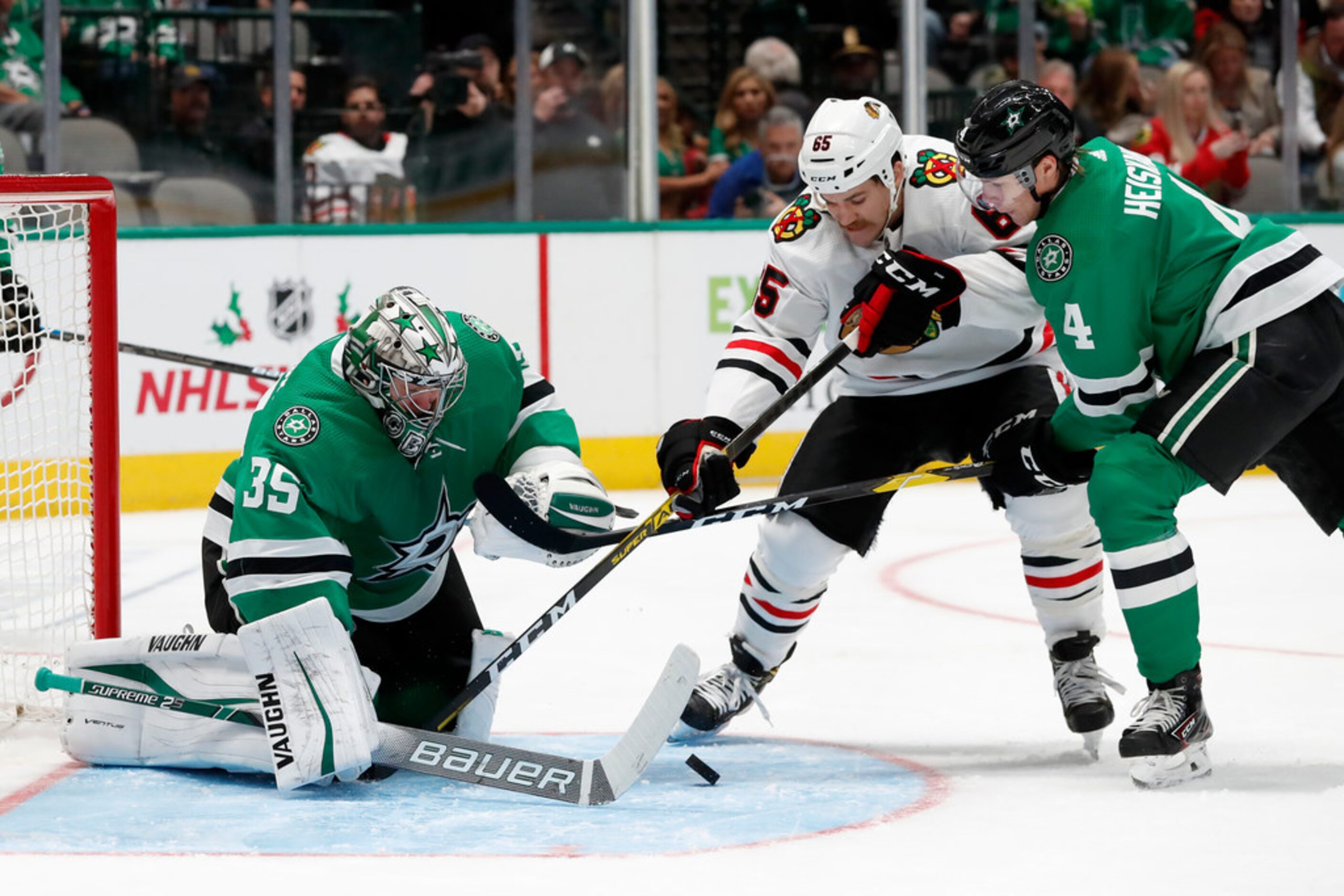 Dallas Stars goaltender Anton Khudobin (35) and defenseman Miro Heiskanen (4) defend the net...