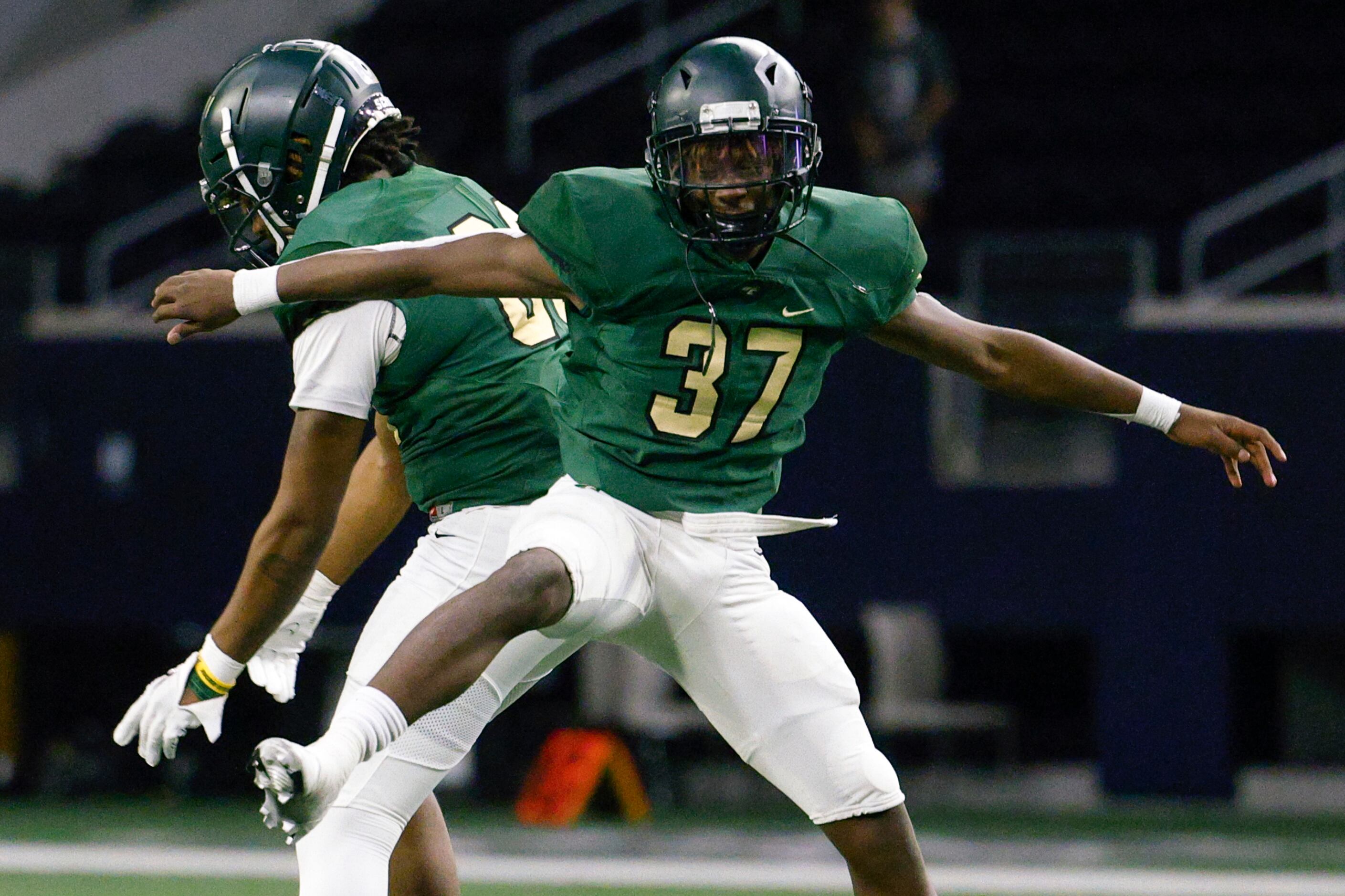 DeSoto’s Aundre Wisner (37) celebrates a touchdown after a blocked punt with Dahlyn Jones...