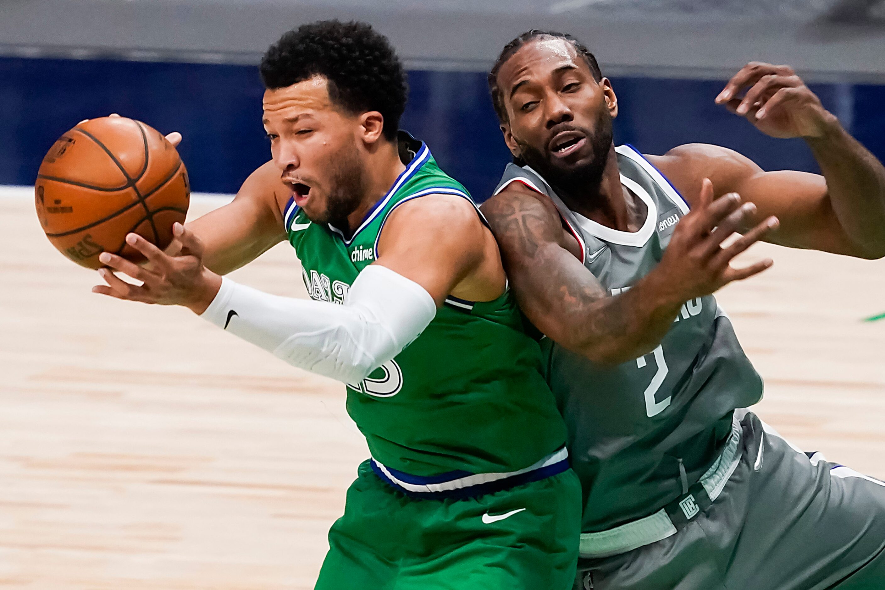 Dallas Mavericks guard Jalen Brunson (13) grabs a rebound away from LA Clippers forward...