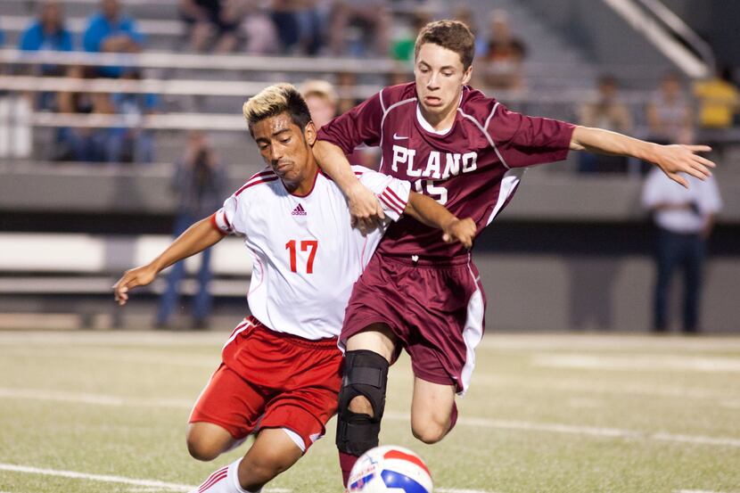 Plano junior midfielder Jessey Hein (right) fights for the ball with Richland senior...