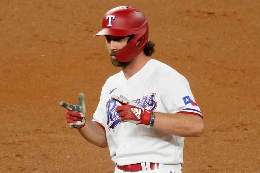Texas Rangers' Charlie Culberson stands on second after a double during the second inning of...