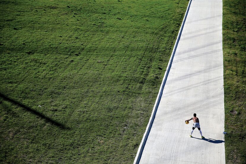 James Watkins of Dallas took advantage of the unseasonably warm weather to work out on the...