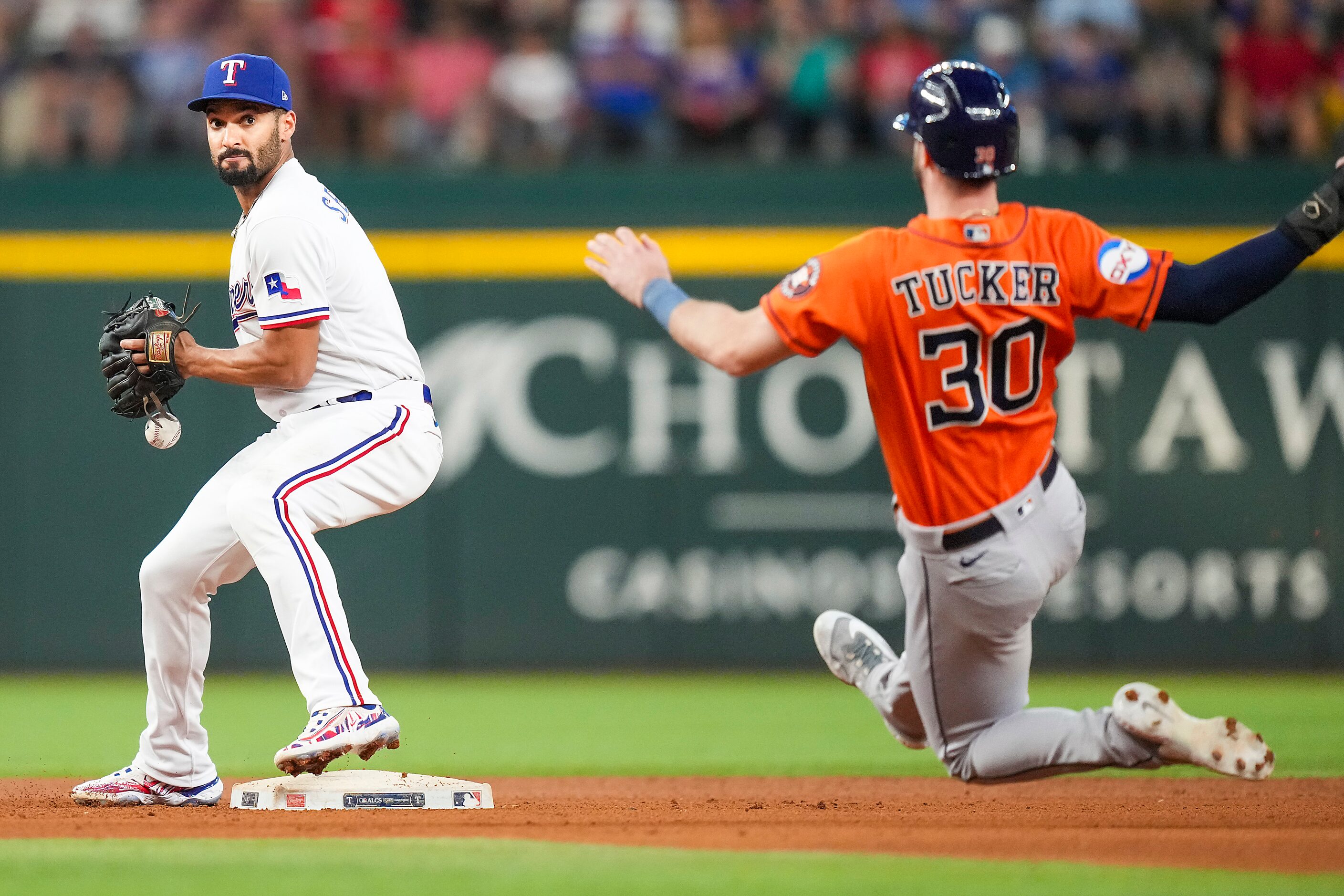 Texas Rangers and second baseman Marcus Semien commits an error allowing Houston Astros...