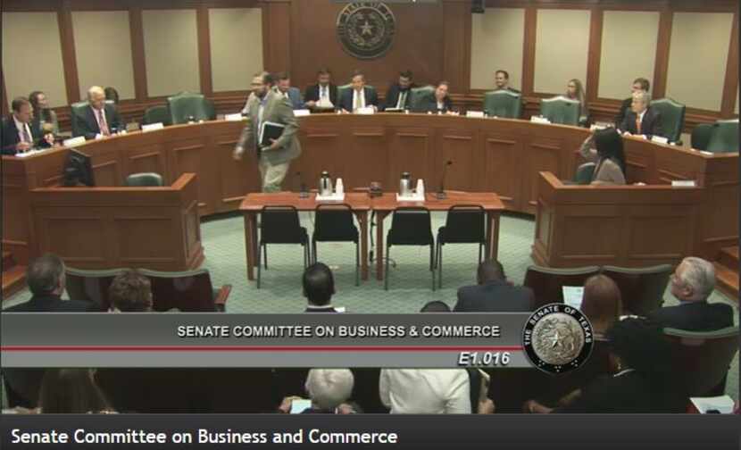 Ware V. Wendell, leader of Texas Watch, is shown at center walking away from Texas Senate...