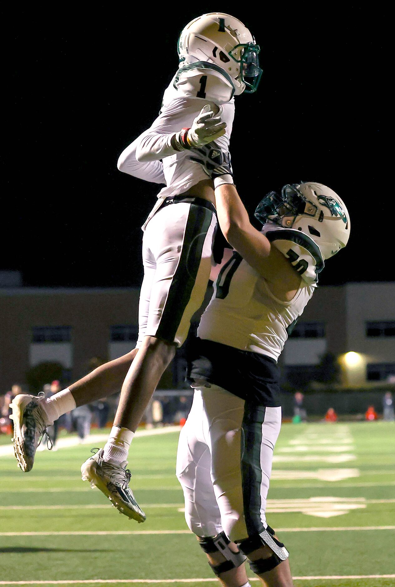 Prosper wide receiver Hunter Summers (1) celebrates with offensive lineman Zach Barnhouse...