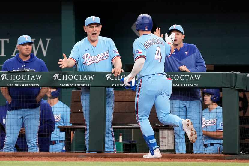 Texas Rangers' Robbie Grossman (4) celebrates his three-run home run with manager Bruce...