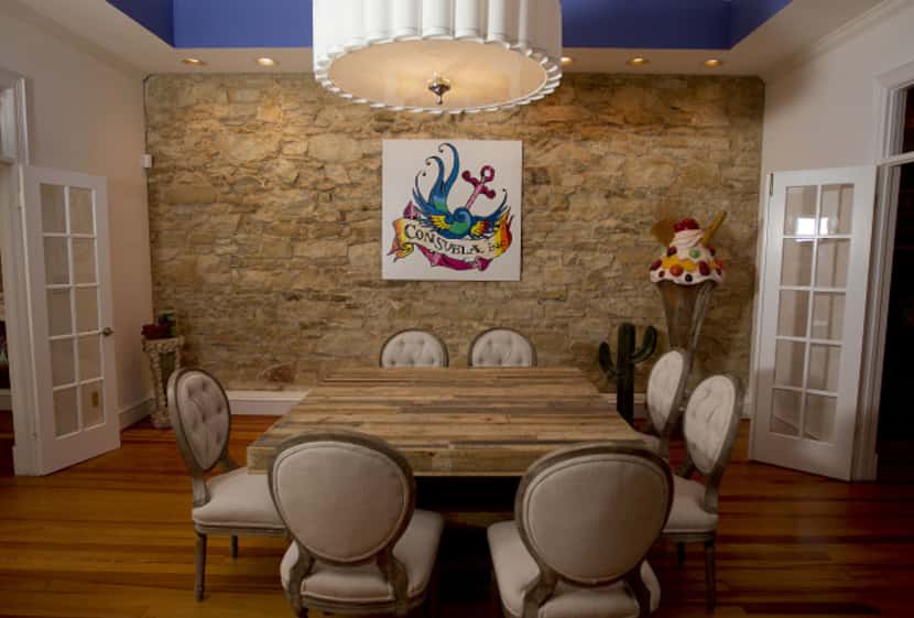 A stone wall provides a dramatic backdrop for the dining room upstairs at  Consuela's new...