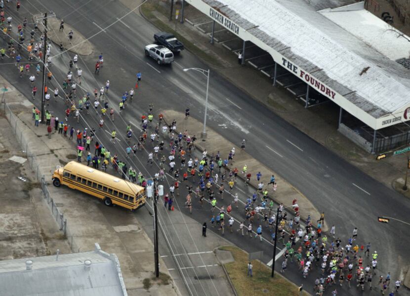 Runners make their along Commerce Street in West Dallas during the MetroPCS Dallas Marathon...