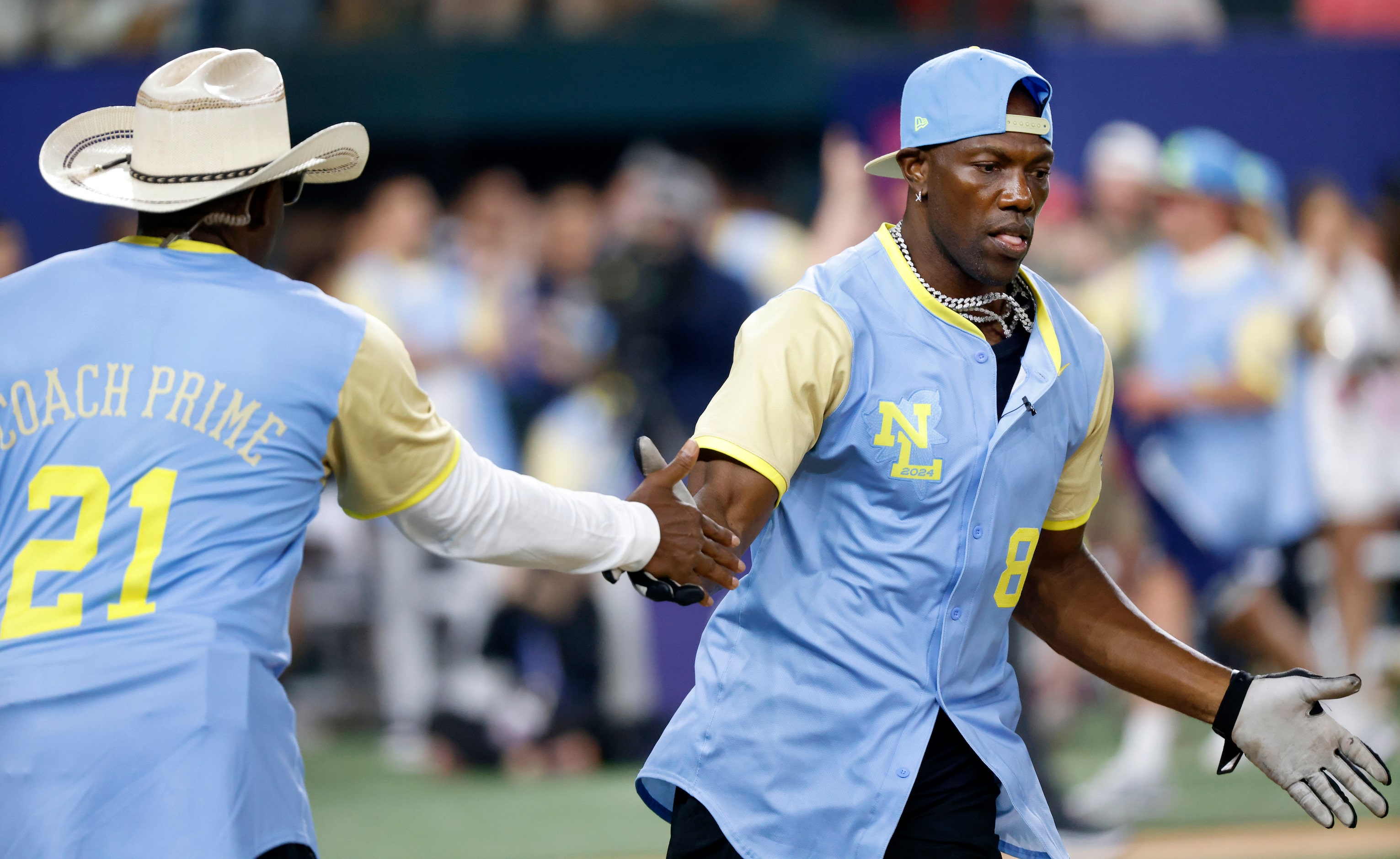 Former Dallas Cowboys Pro Football Hall of Famer Terrell Owens is congratulated by teammate...