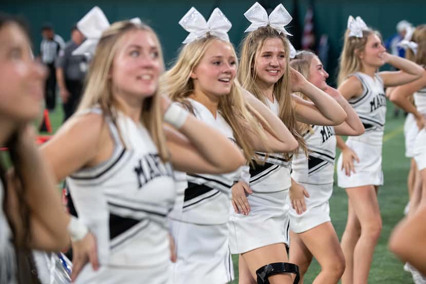 Sophomore Mia Wager, third from right, dances while cheering for Arlington Martin during a...