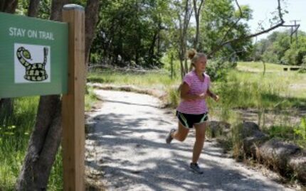  Tryn Harper, professor of physical education at Cedar Valley College, jogs inÂ the...