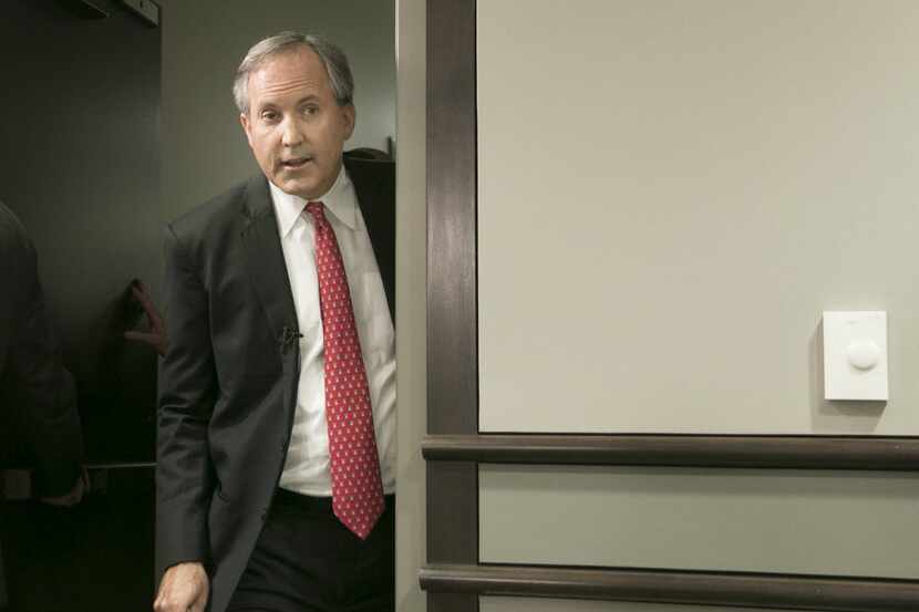 Republican Texas Attorney General Ken Paxton arrives at a press conference where he...