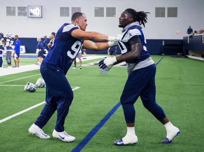 Dallas Cowboys defensive end Demarcus Lawrence (90) takes on defensive tackle Tyrone...