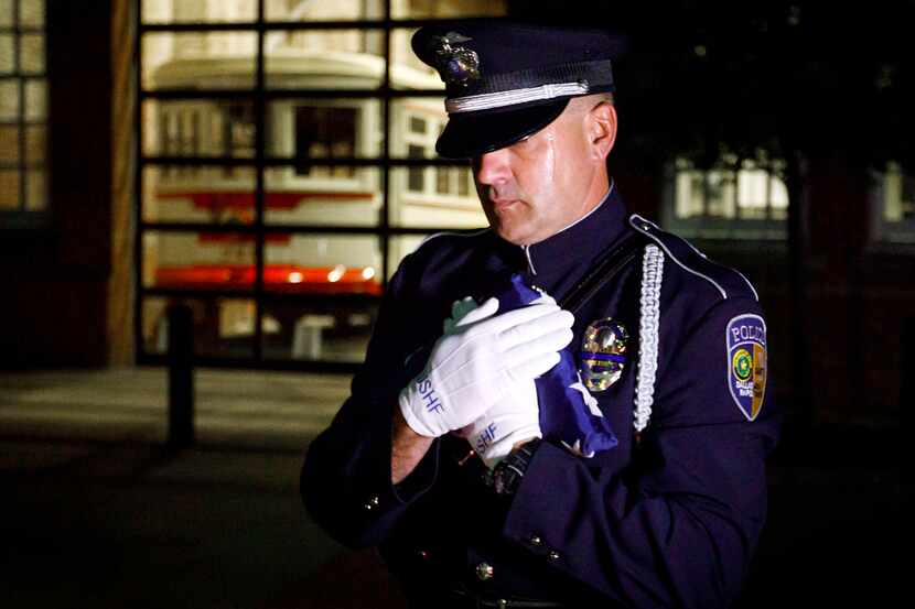 DART Police officer Chris Cobb carries the US Honor Flag as the flag arrives at DART Police...