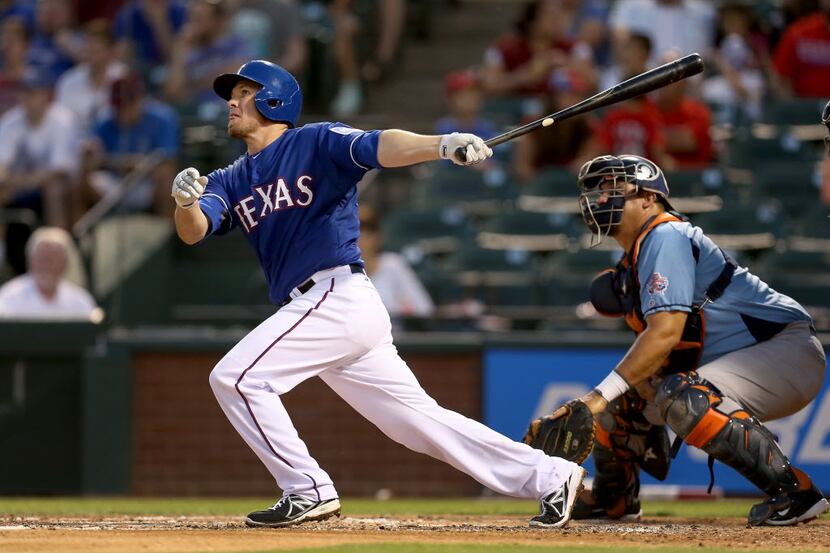Texas Rangers second baseman Donnie Murphy (16) hits a three-run home run against the...
