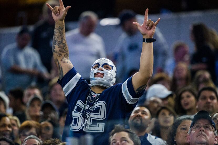 A Dallas Cowboys fan cheers during the fourth quarter of their game against the Detroit...
