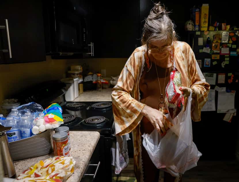 Dixie Perkins put away groceries from her visit to Community Food Pantry in McKinney on...