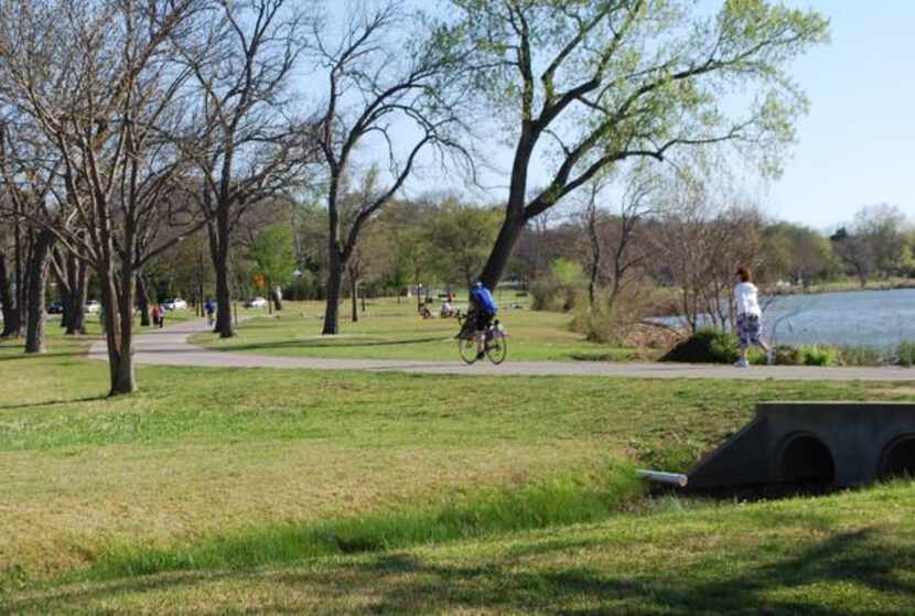 People run and cycle along the White Rock Lake Trail at Winfrey Point. The White Rock Lake...