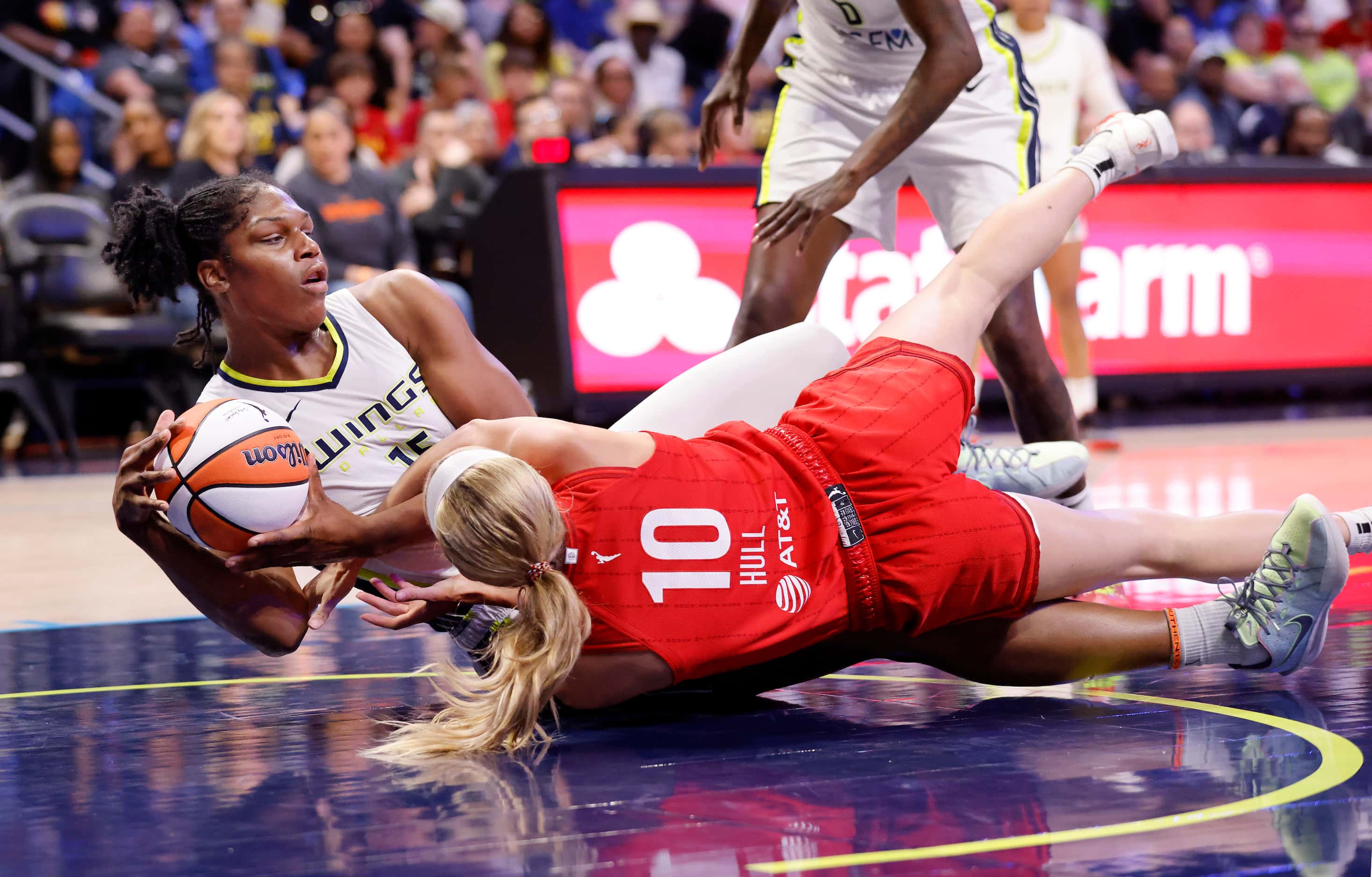 Dallas Wings center Teaira McCowan (15) wrestles the ball away from Indiana Fever guard...