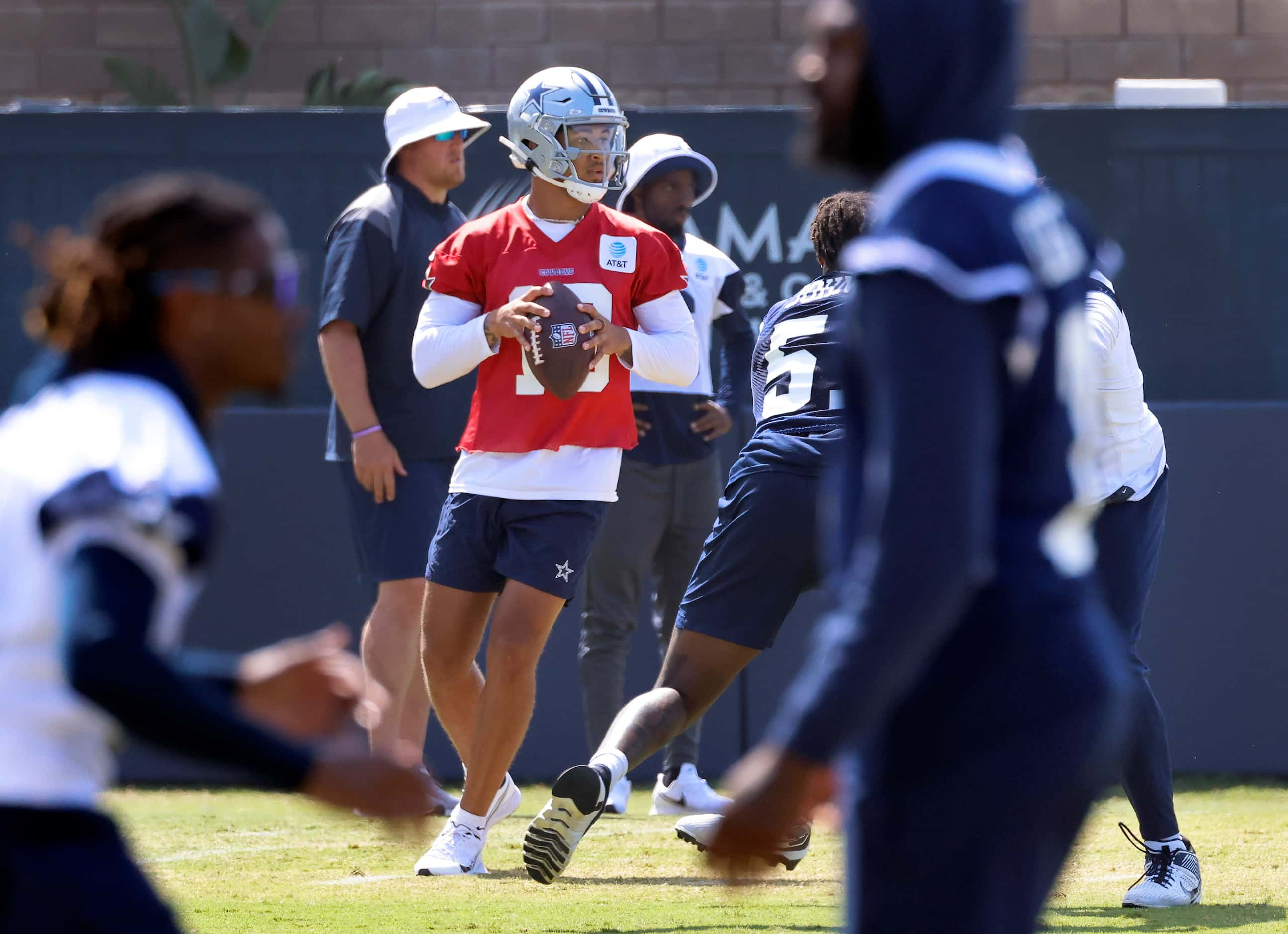 Dallas Cowboys quarterback Trey Lance (19) drops back to pass during a mock game walk thru...