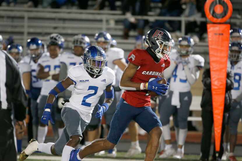 John Paul II WR Jerand Bradley (9) catches a pass and runs for a touchdown as he is chased...